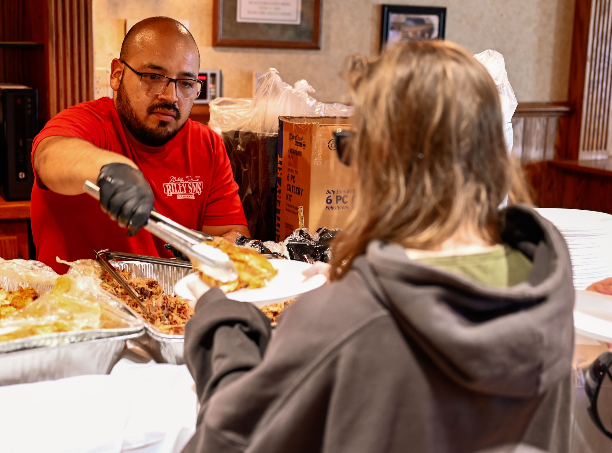 A caterer serves attendees at the 552nd Air Control Wing’s 70th Anniversary picnic held March 28 at the Tinker Event Center.
(U.S. Air Force photo by Garrett N. Cole)