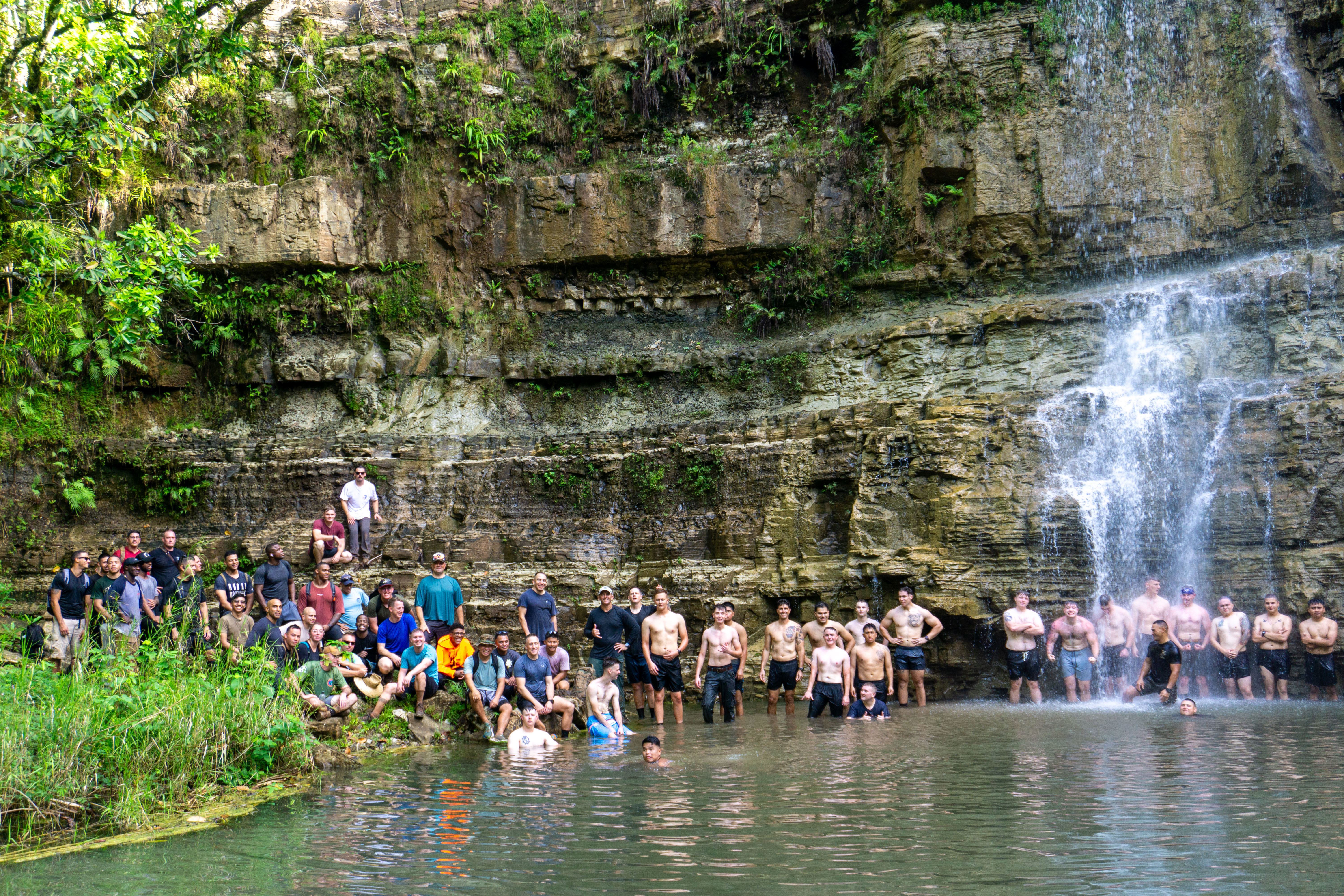 U.S. Marines with Marine Corps Base Camp Blaz pose for a picture during a unit hike at Sigua Falls, Guam, March 24, 2025. The hike was conducted to increase physical fitness and build unit cohesion.  (U.S. Marine Corps photo by Chelsey Suarez-Pierce)