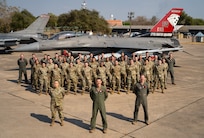 U.S. Air Force Airmen assigned to the 77th Expeditionary Fighter Squadron stand in formation for a group photo during Cope Tiger 25, at Korat Royal Air Base, Thailand, Mar. 7, 2025.