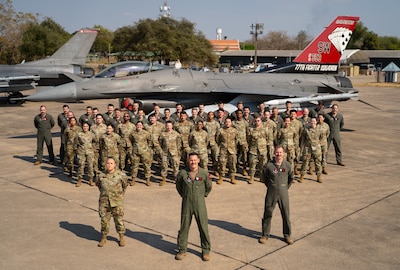U.S. Air Force Airmen assigned to the 77th Expeditionary Fighter Squadron stand in formation for a group photo during Cope Tiger 25, at Korat Royal Air Base, Thailand, Mar. 7, 2025.