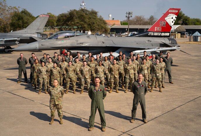 U.S. Air Force Airmen assigned to the 77th Expeditionary Fighter Squadron stand in formation for a group photo during Cope Tiger 25, at Korat Royal Air Base, Thailand, Mar. 7, 2025.