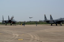 A U.S. Air Force F-16 Fighting Falcon, assigned to the 77th Expeditionary Fighter Squadron, takes off in the distance during exercise Cope Tiger 25 at Korat Royal Air Base, Thailand, Mar. 19, 2025.
