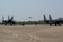 A U.S. Air Force F-16 Fighting Falcon, assigned to the 77th Expeditionary Fighter Squadron, takes off in the distance during exercise Cope Tiger 25 at Korat Royal Air Base, Thailand, Mar. 19, 2025.