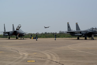 A U.S. Air Force F-16 Fighting Falcon, assigned to the 77th Expeditionary Fighter Squadron, takes off in the distance during exercise Cope Tiger 25 at Korat Royal Air Base, Thailand, Mar. 19, 2025.