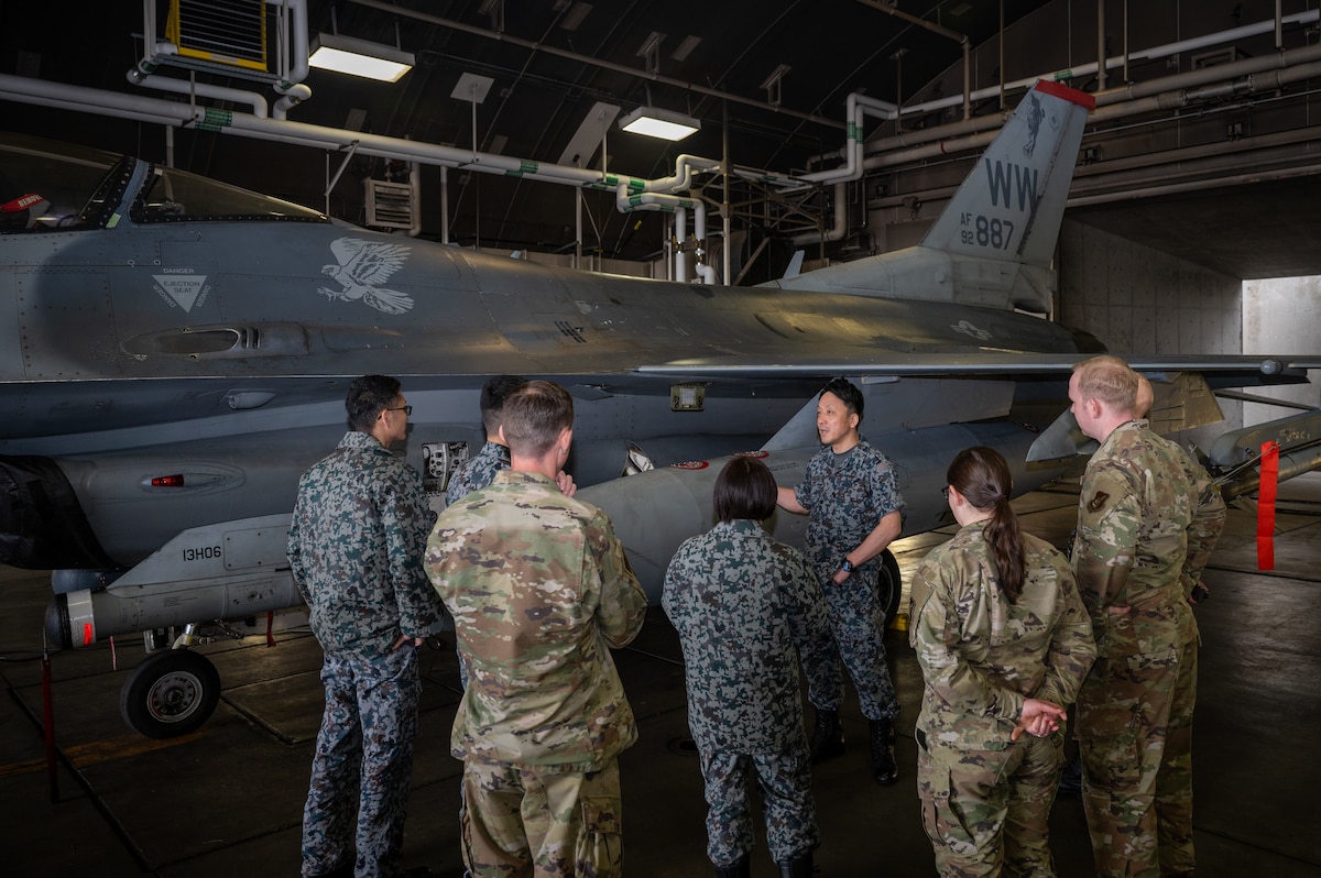 U S Air Force Airmen assigned to the 35th Maintenance Squadron and Japan Air Self Defense Force members discuss aircraft components during an immersion tour at Misawa Air Base, Japan.