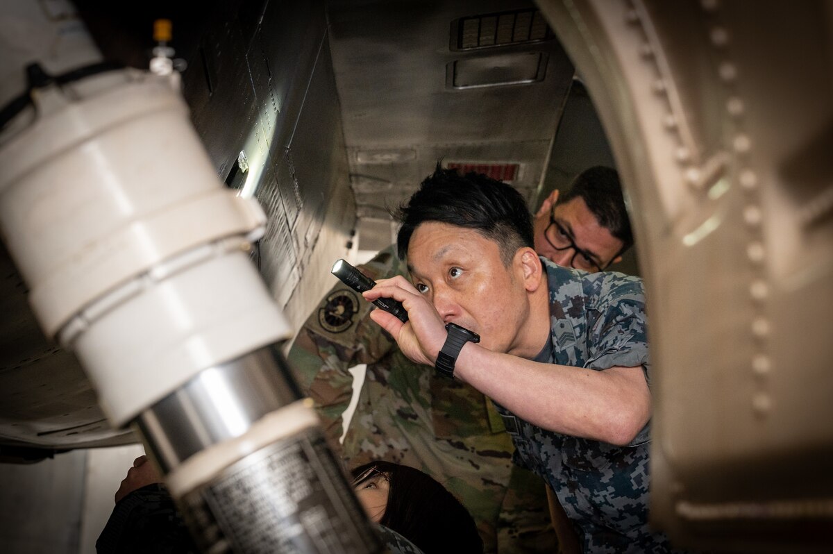 A Japan Air-Self Defense Force member looks inside a U.S. Air Force F 16 Fighting Falcon during an immersion tour at Misawa Air Base, Japan.