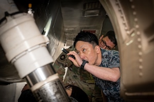 A Japan Air-Self Defense Force member looks inside a U.S. Air Force F 16 Fighting Falcon during an immersion tour at Misawa Air Base, Japan.