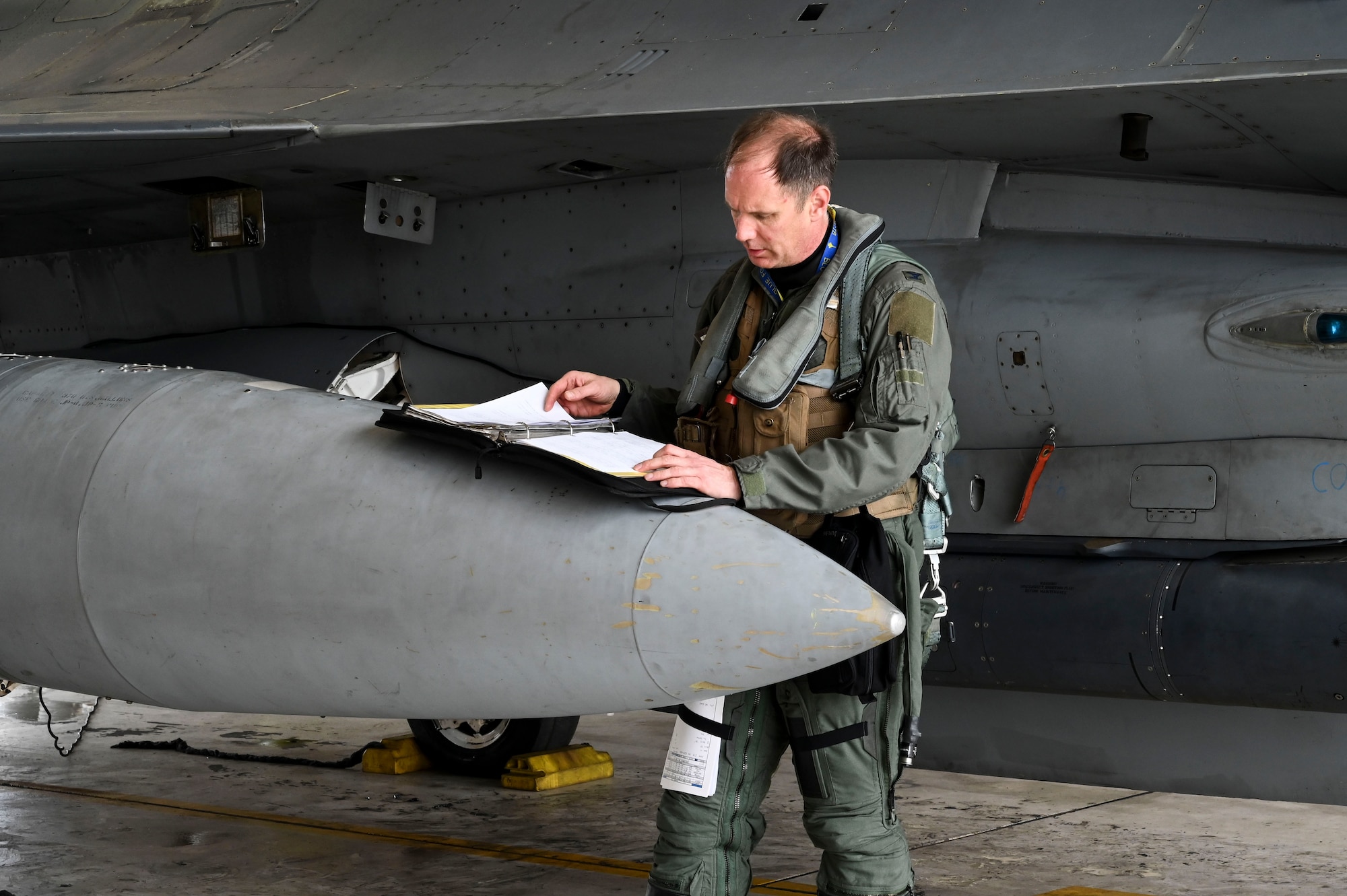 U.S. Air Force Col. Peter "Wolf" Kasarskis, 8th Fighter Wing commander, performs pre-flight checks on an F-16 Fighting Falcon aircraft during Freedom Flag 25-1 at Kunsan Air Base, Republic of Korea, April 23, 2025.