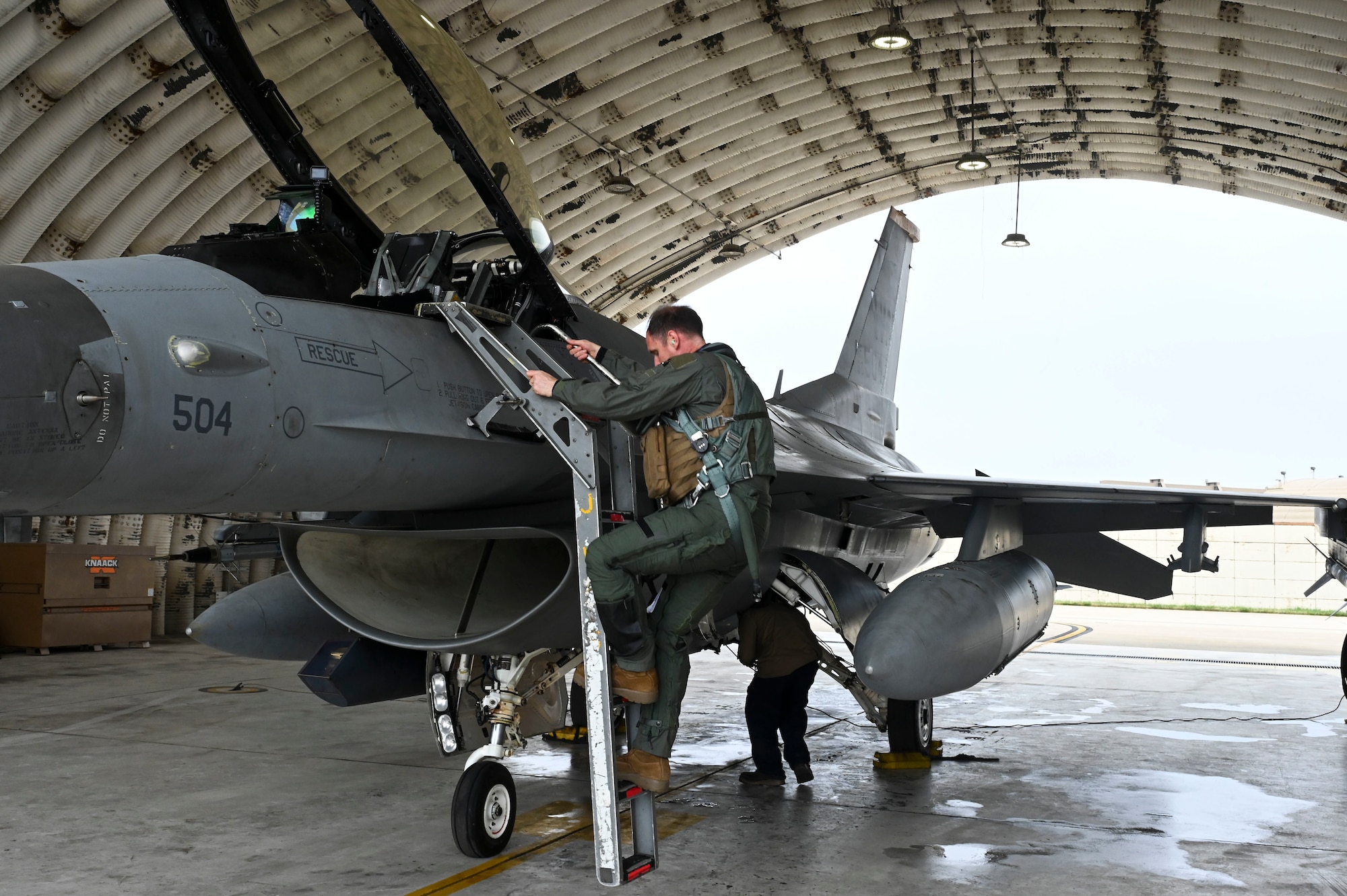 U.S. Air Force Col. Peter "Wolf" Kasarskis, 8th Fighter Wing commander, climbs into an F-16 Fighting Falcon aircraft during exercise Freedom Flag 25-1 at Kunsan Air Base, Republic of Korea, April 23, 2025.