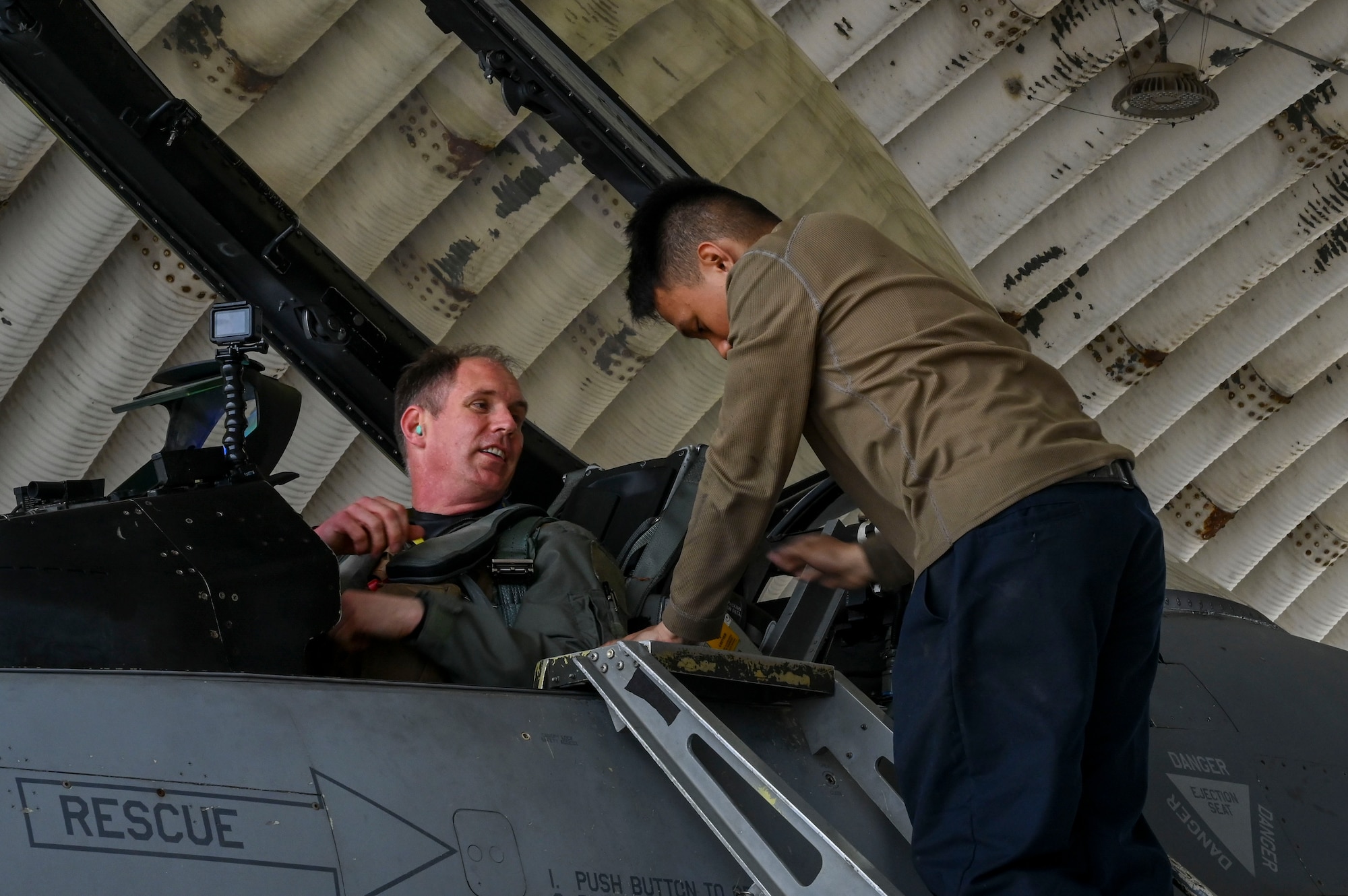 U.S. Air Force Col. Peter "Wolf" Kasarskis, 8th Fighter Wing commander, speaks with Airman 1st Class Matthew Navarro, 35th Fighter Generation Squadron F-16 Fighting Falcon crew chief, while performing pre-flight checks during exercise Freedom Flag 25-1 at Kunsan Air Base, Republic of Korea, April 23, 2025.