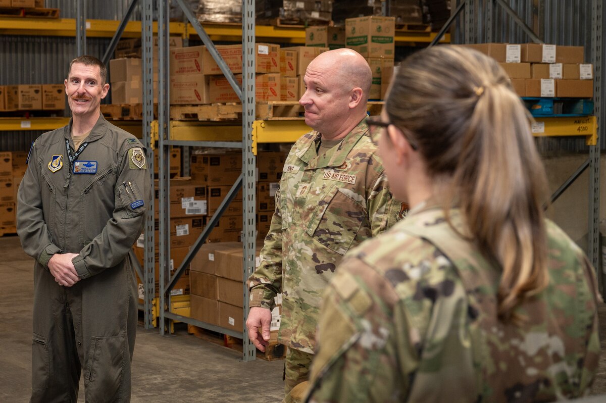 U S Air Force Chief Master Sergeant. Fred King, middle, 35th Operations Group senior enlisted leader, speaks with U S Air Force Colonel. Gregory Keller, 35th Operations Group commander, and Master Sergeant. Amy Tordera, 35th Force Support Squadron resource management noncommissioned officer in charge, during a Wild Weasel Walk-through at Misawa Air Base, Japan.