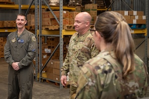 U S Air Force Chief Master Sergeant. Fred King, middle, 35th Operations Group senior enlisted leader, speaks with U S Air Force Colonel. Gregory Keller, 35th Operations Group commander, and Master Sergeant. Amy Tordera, 35th Force Support Squadron resource management noncommissioned officer in charge, during a Wild Weasel Walk-through at Misawa Air Base, Japan.