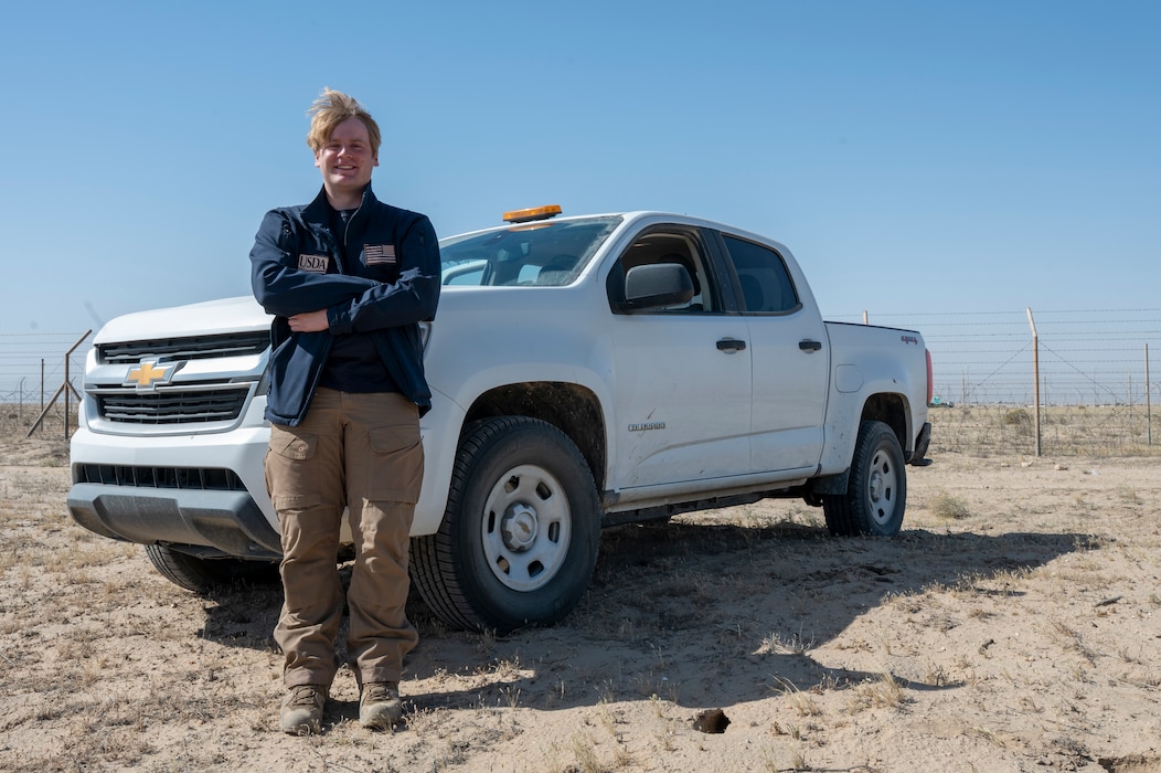 Noah Baity stands arms crossed in front of his safety truck