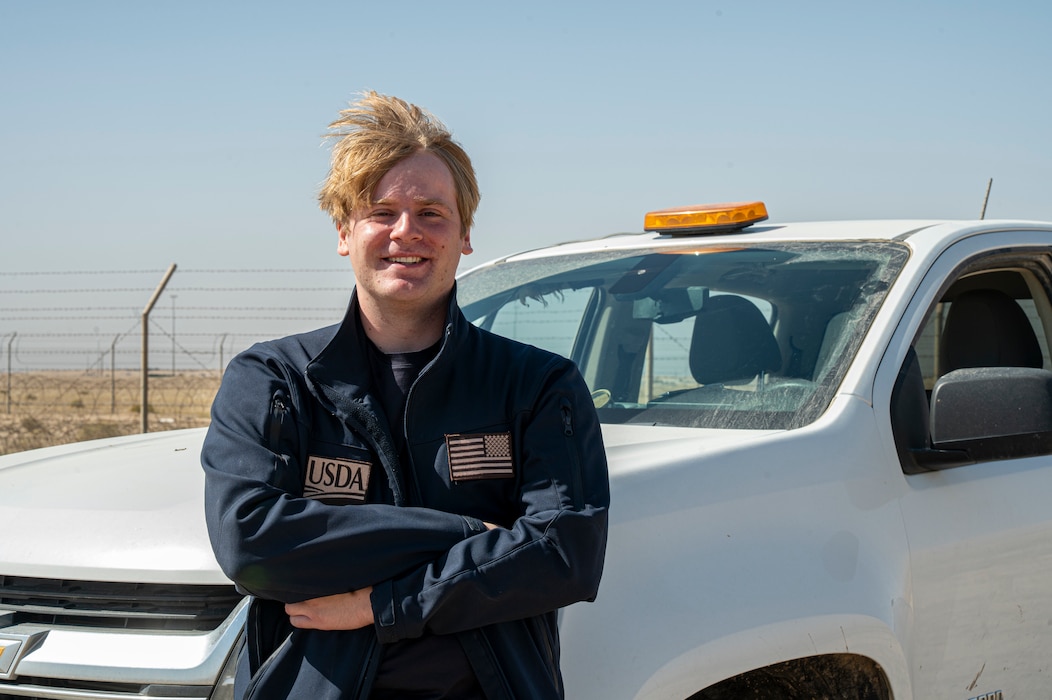 Noah Baity stands arms crossed in front of his safety truck