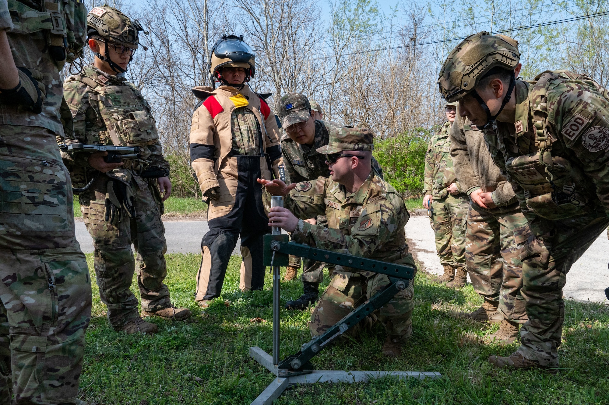 Airman shows ROKAF EOD how to assemble an Explosive Ordnance Disruptor.