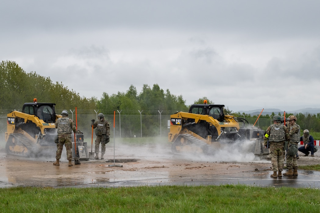 Airman and machines cut concrete on a runway.
