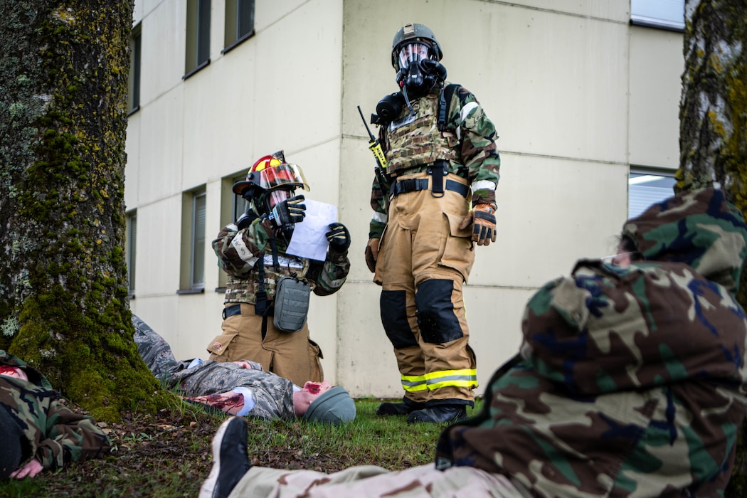 Firefighters in hazmat suits triage victims of a CBRN attack