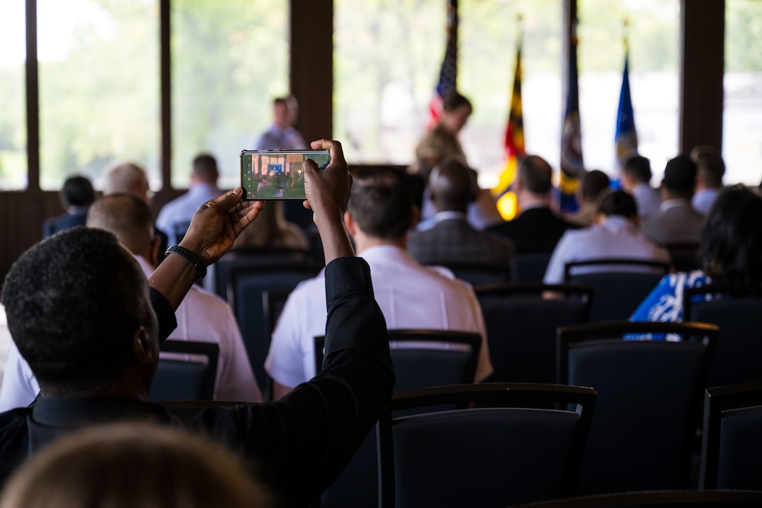 An attendee takes a photo during the State of the Base address.