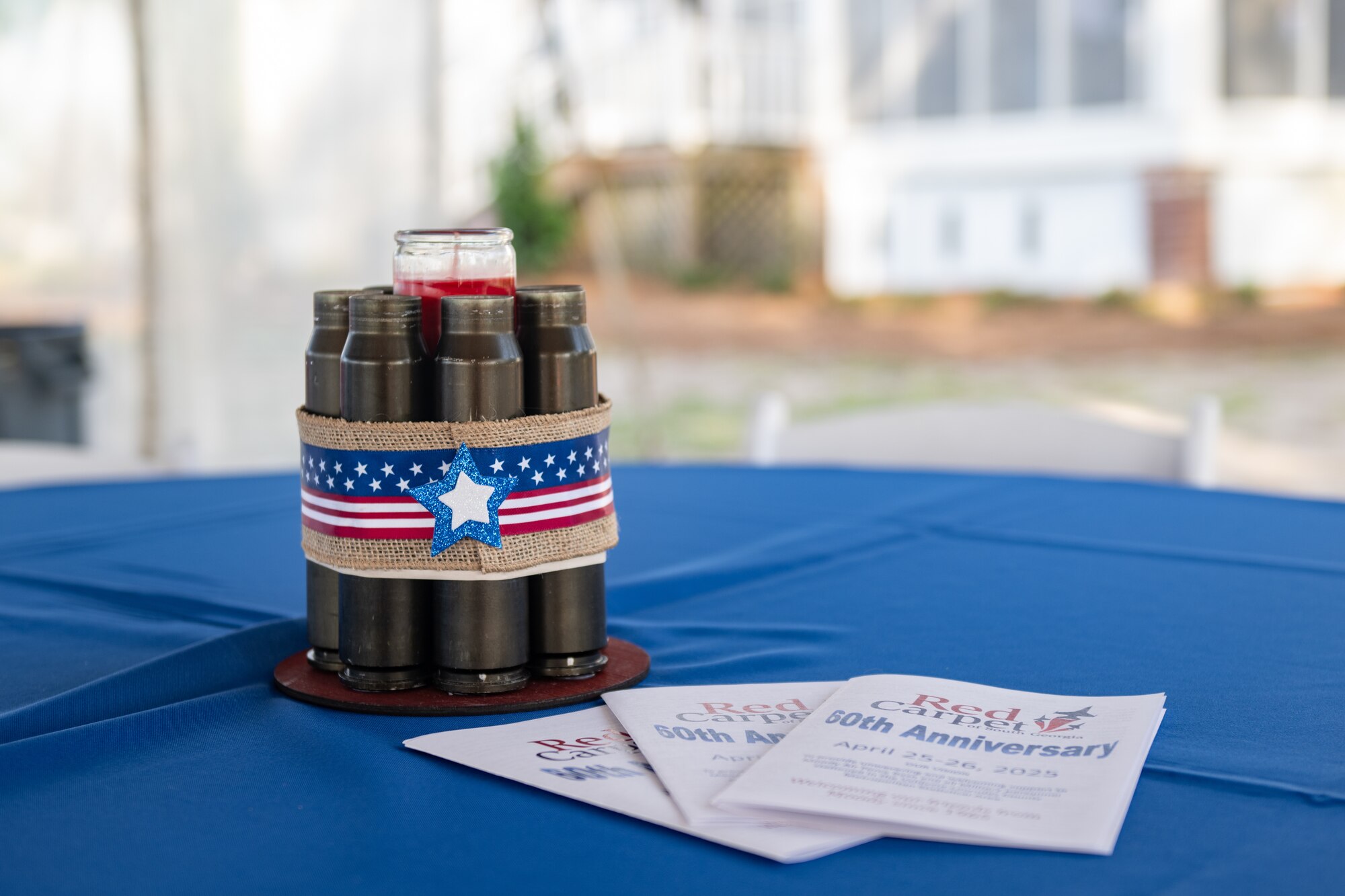 Decorations and pamphlets for the 60th Anniversary of Red Carpet of South Georgia event are on a table.