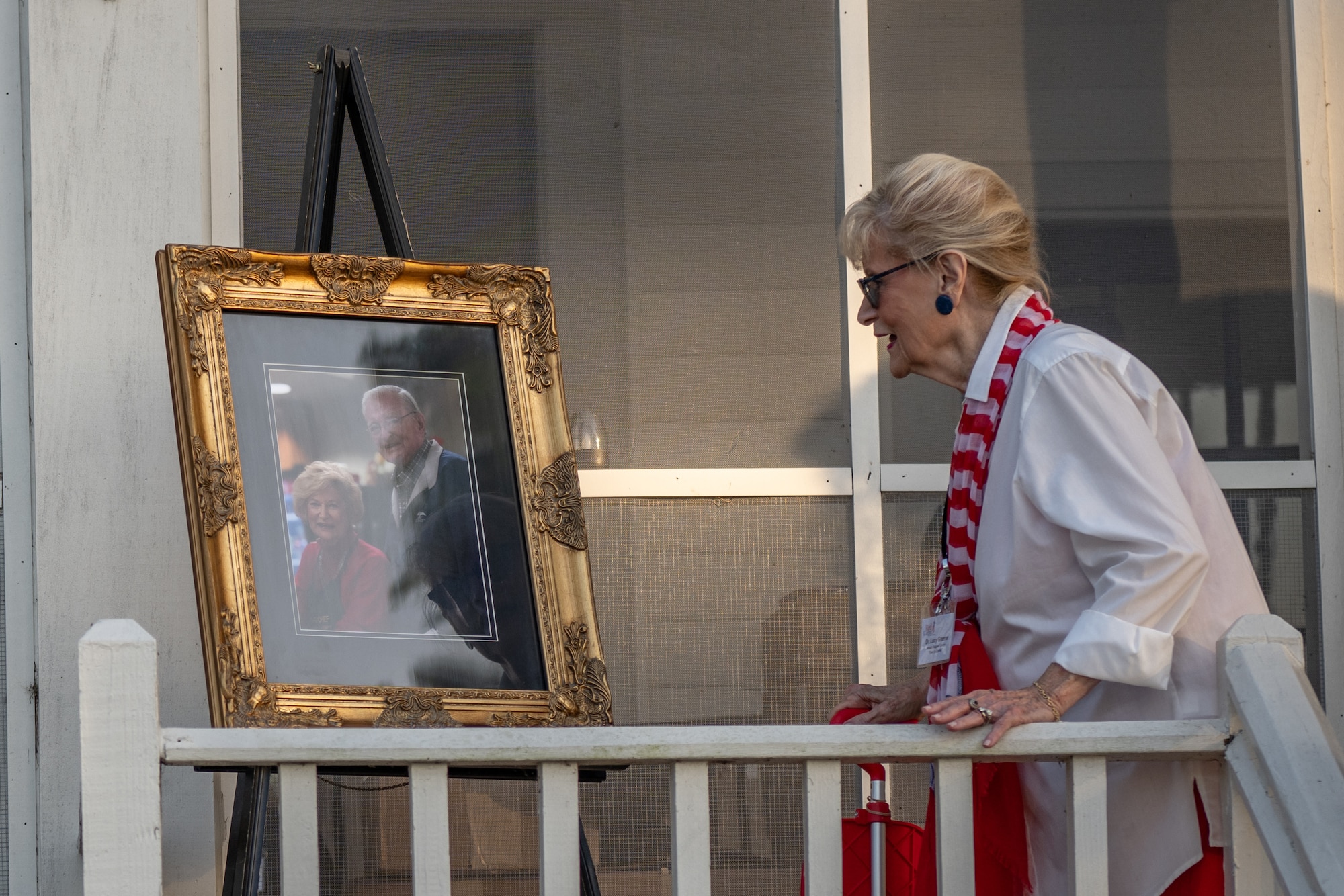 Dr. Lucy admires the photo of her and her husband.