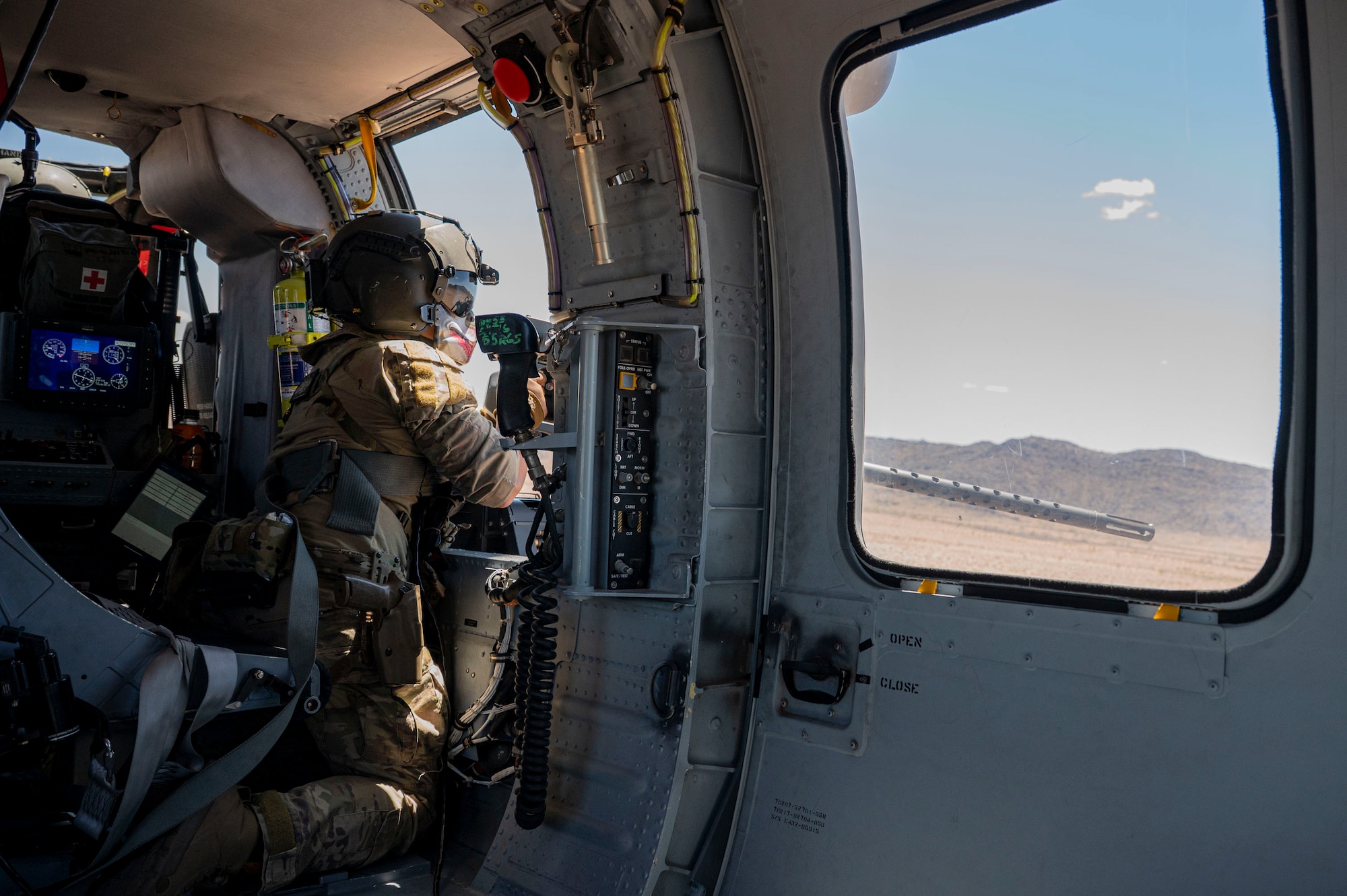 A U.S. Air Force pararescueman assigned to the 55th Rescue Squadron shoots a GAU-21 machine gun during a training sortie at Gila Bend, Arizona, April 29, 2025. The 55th RQS continuously executes their mission by flying training sorties and performing simulated combat search and rescue scenarios to ensure they are prepared when real-world rescues arise. (U.S. Air Force photo by Airman Samantha Melecio)