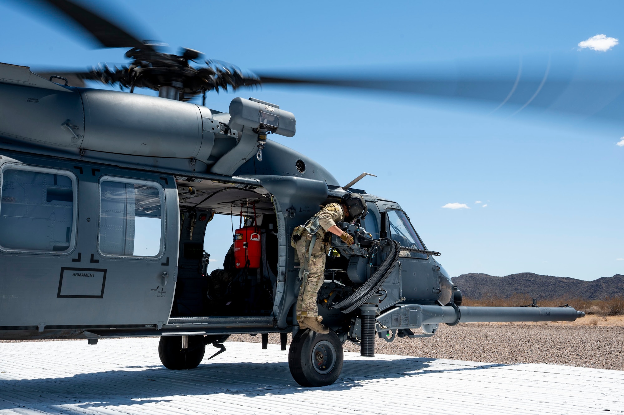 A U.S. Air Force pararescueman assigned to the 55th Rescue Squadron checks equipment on an HH-60W Jolly Green II helicopter during a training sortie at Gila Bend, Arizona, April 29, 2025. The 55th RQS executed a training sortie with the HH-60W to reinforce combat proficiency and sustain readiness for high-risk rescue and recovery operations. (U.S. Air Force photo by Airman Samantha Melecio)
