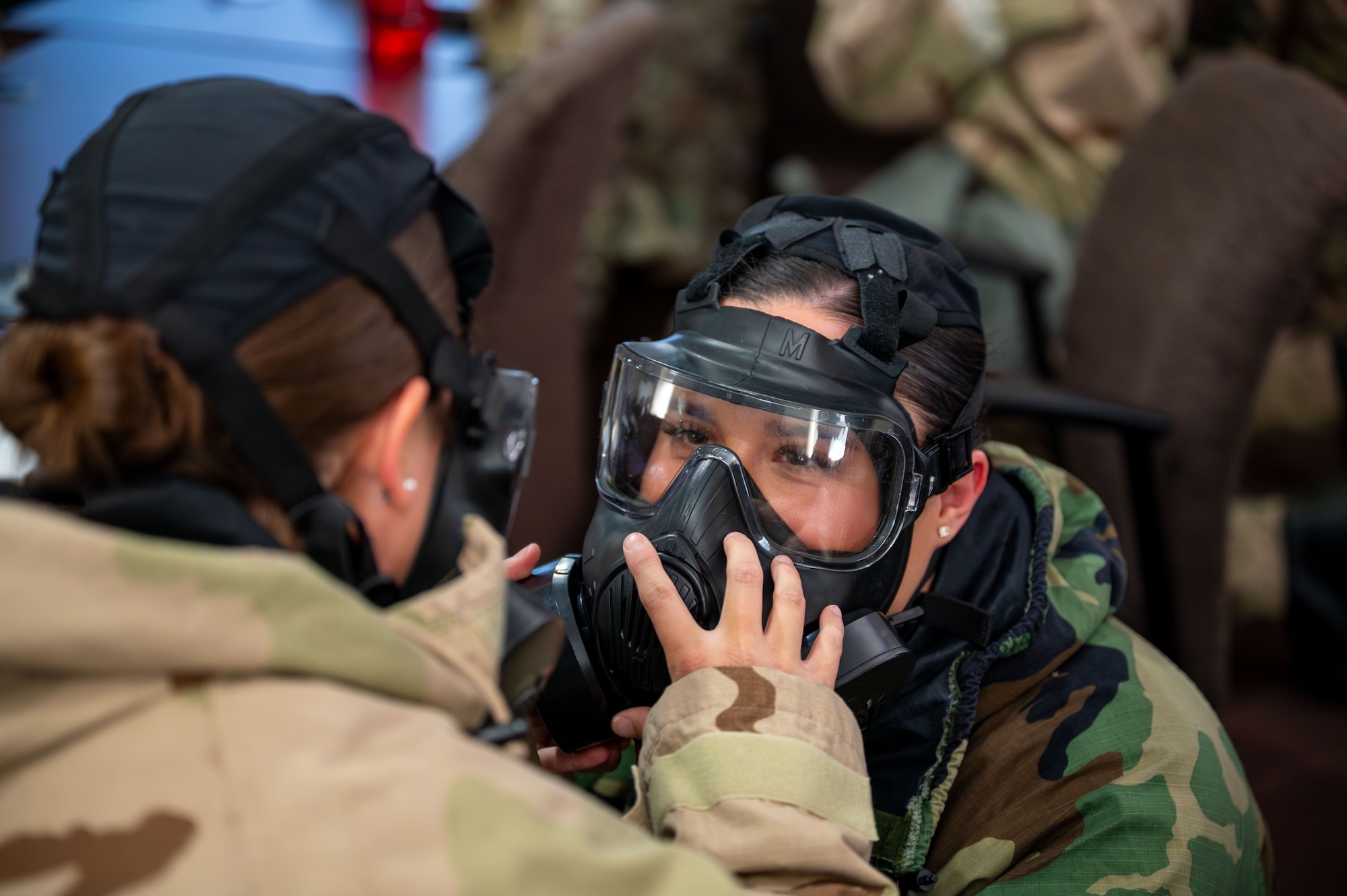 U.S. Airmen assigned to the 11th Combat Air Base Squadron perform buddy checks on their gas masks at Davis-Monthan Air Force Base, Arizona, April 28, 2025. The checks ensured proper equipment fit and function in the event of a chemical, biological, radiological and nuclear threat scenario. (U.S. Air Force photo by Senior Airman Jasmyne Bridgers-Matos)
