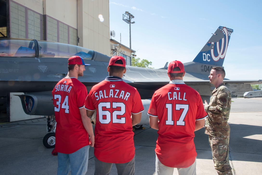 Washington Nationals players Michael Soroka, Eduardo Salazar and Alex Call receive a briefing on the 113th Wing’s mission and the F-16 Fighting Falcon aircraft capabilities from U.S. Air Force Master Sgt. Dalton Yeager, 113th Aircraft Maintenance Squadron, at Joint Base Andrews, Md., April 23, 2025