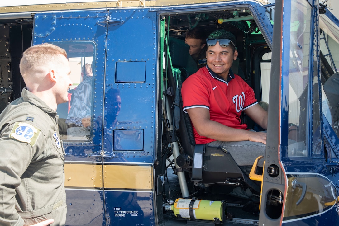 U.S. Air Force Capt. Alexander J. Jones, 1st Helicopter Squadron assistant flight commander, familiarizes Eduardo Salazar, a pitcher with the Washington Nationals, with the UH-1N Huey helicopter’s cockpit at Joint Base Andrews, Md., April 23, 2025.
