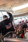 A veteran waves at the crowd during the Western North Dakota Honor Flight homecoming at Minot International Airport in Minot, N.D., April 28, 2025. Veterans were welcomed by family, friends and supporters after visiting Washington, D.C. memorials honoring their military service. (U.S. Air Force photo by Airman 1st Class Luis Gomez)