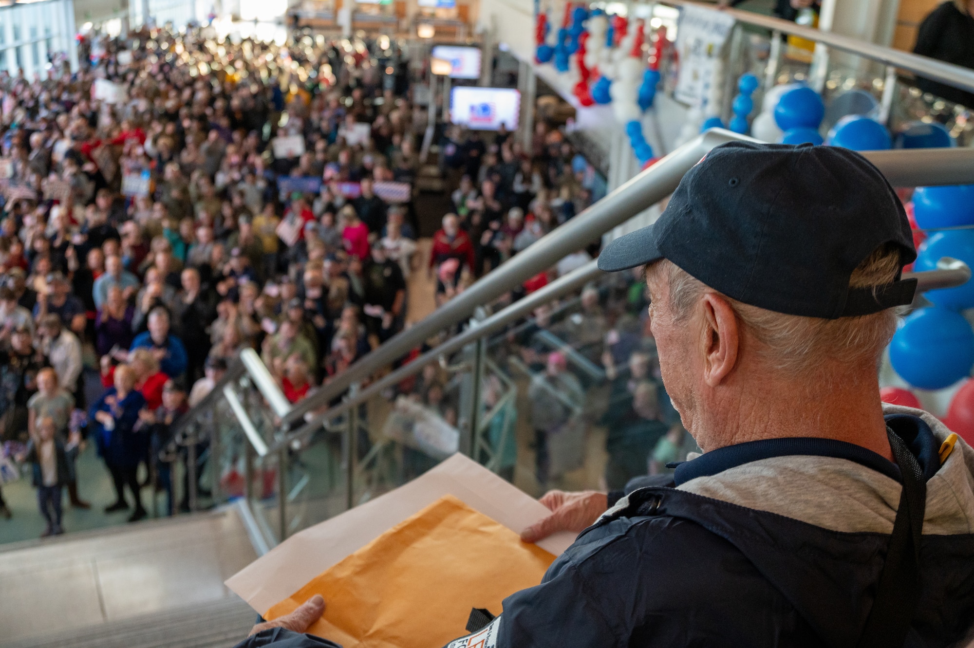 A veteran overlooks the cheering crowd during the Western North Dakota Honor Flight homecoming at Minot International Airport in Minot, N.D., April 28, 2025. Veterans were welcomed by family, friends and supporters after visiting Washington, D.C. memorials honoring their military service. (U.S. Air Force photo by Airman 1st Class Luis Gomez)