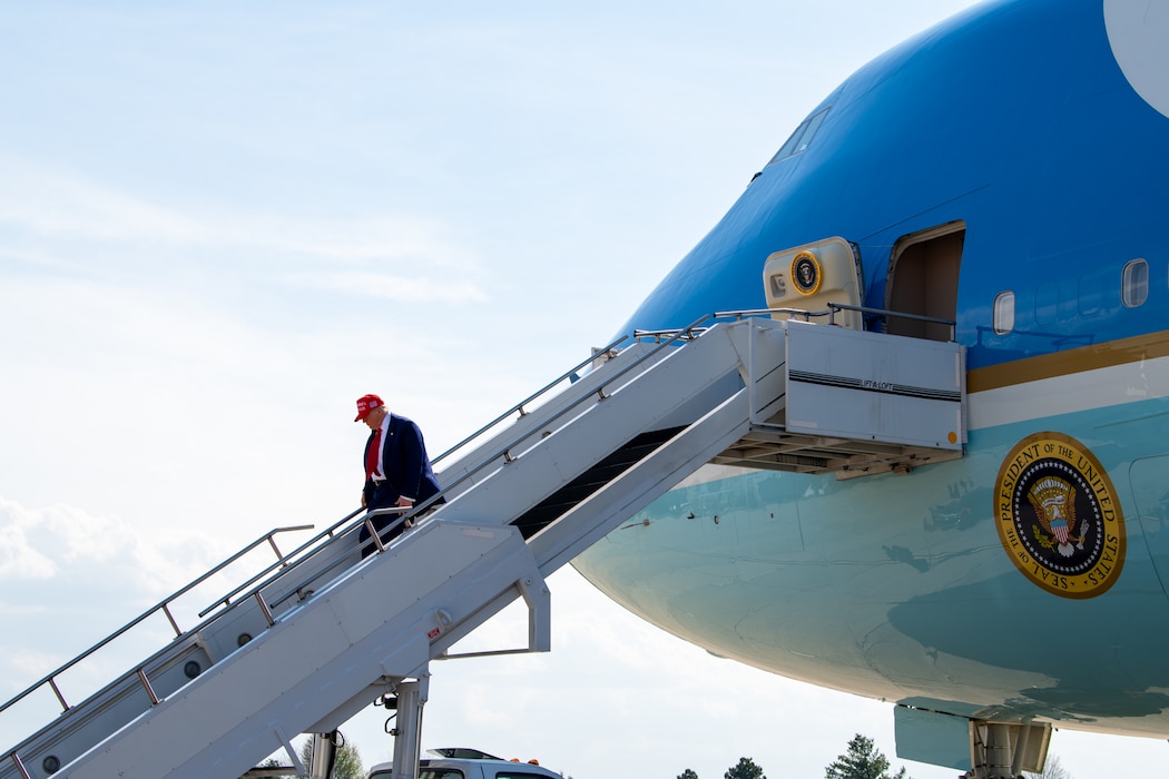 President descending steps from Air Force One.