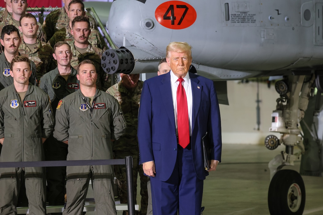 President in business suit stands in front