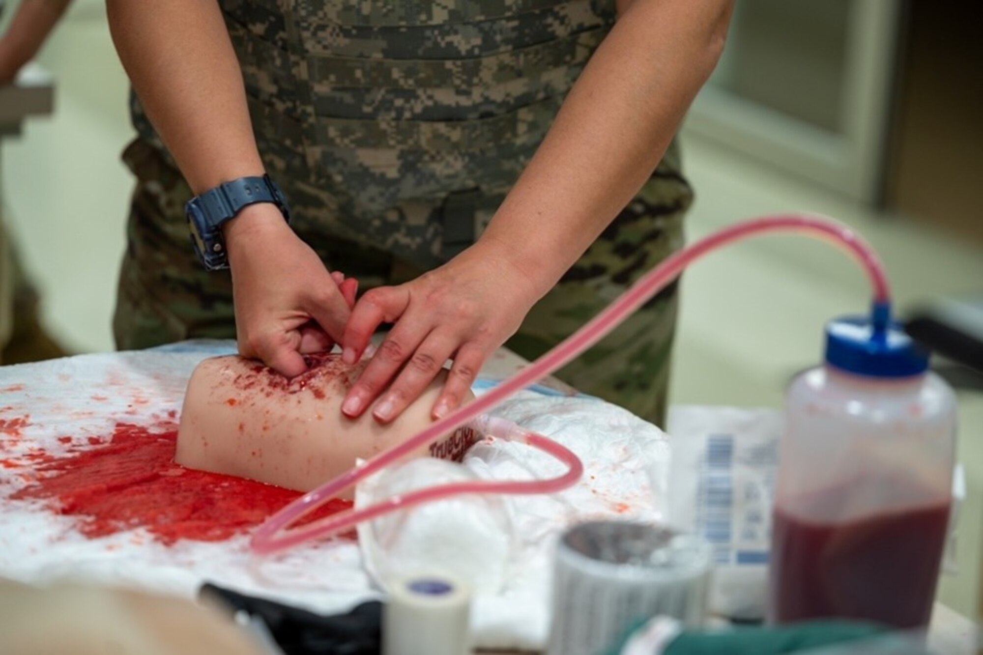 Airman digs finger into mannequin limb. (U.S. Air Force photo by Airman 1st Class Donnell Ramsey)