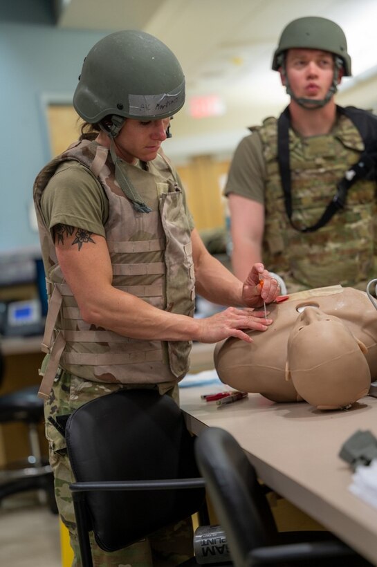 Airman punctures a mannequin in the chest. (U.S. Air Force photo by Airman 1st Class Donnell Ramsey)