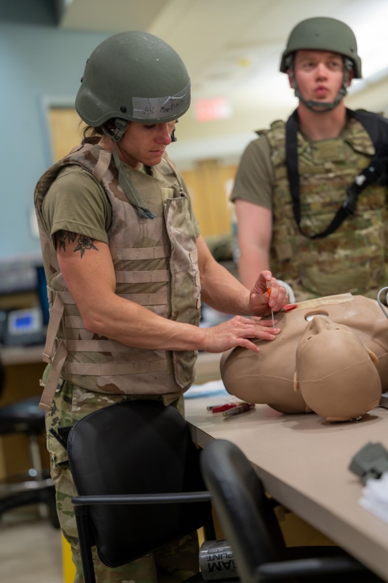 Airman punctures a mannequin in the chest. (U.S. Air Force photo by Airman 1st Class Donnell Ramsey)