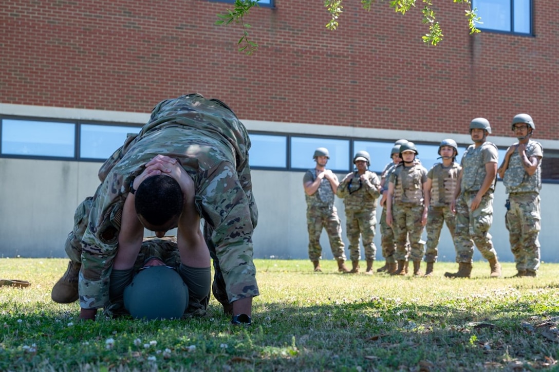 Airmen perform a neck drag. (U.S. Air Force photo by Airman 1st Class Donnell Ramsey)