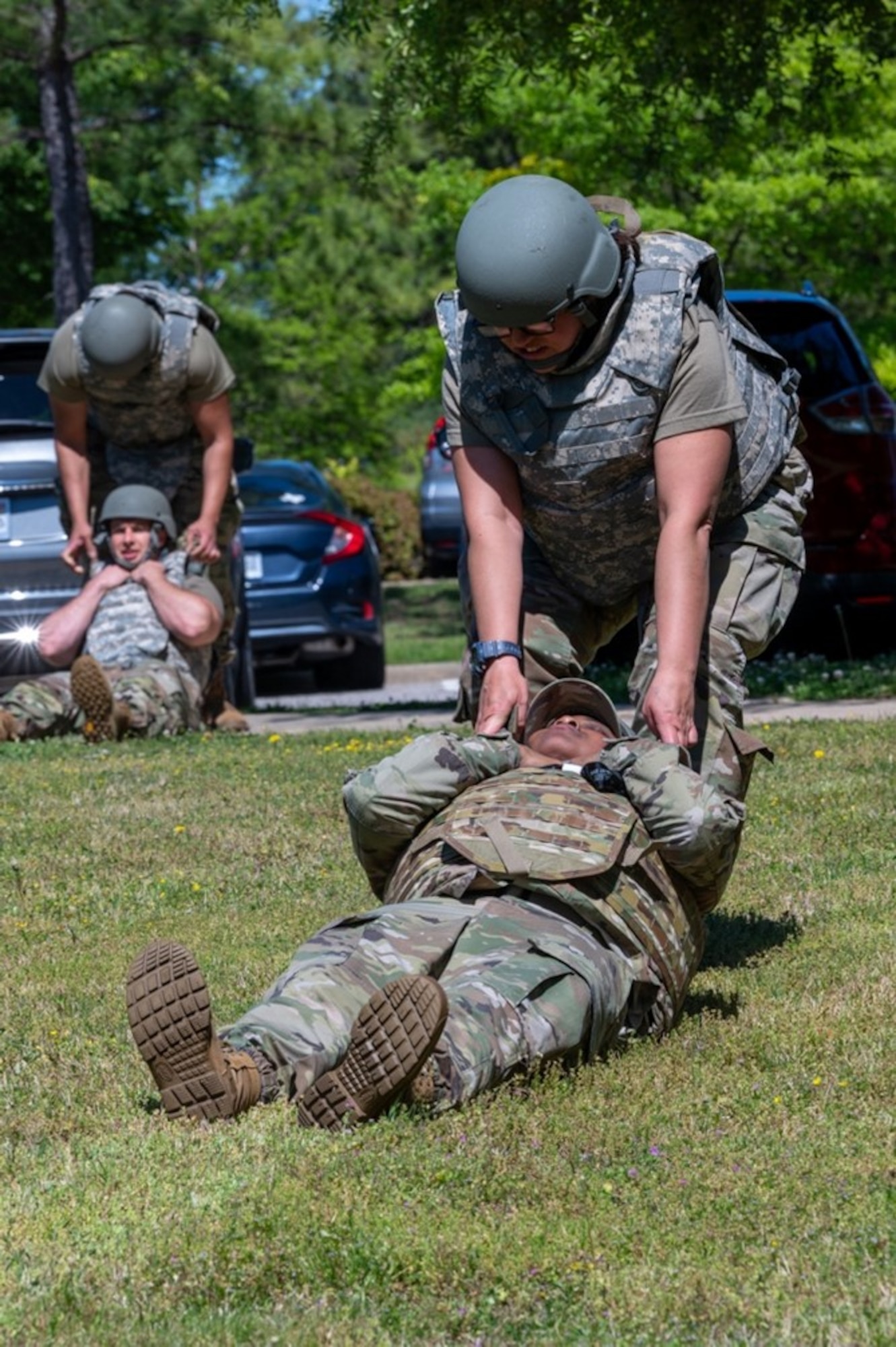 Airmen drag other Airmen across field. (U.S. Air Force photo by Airman 1st Class Donnell Ramsey)