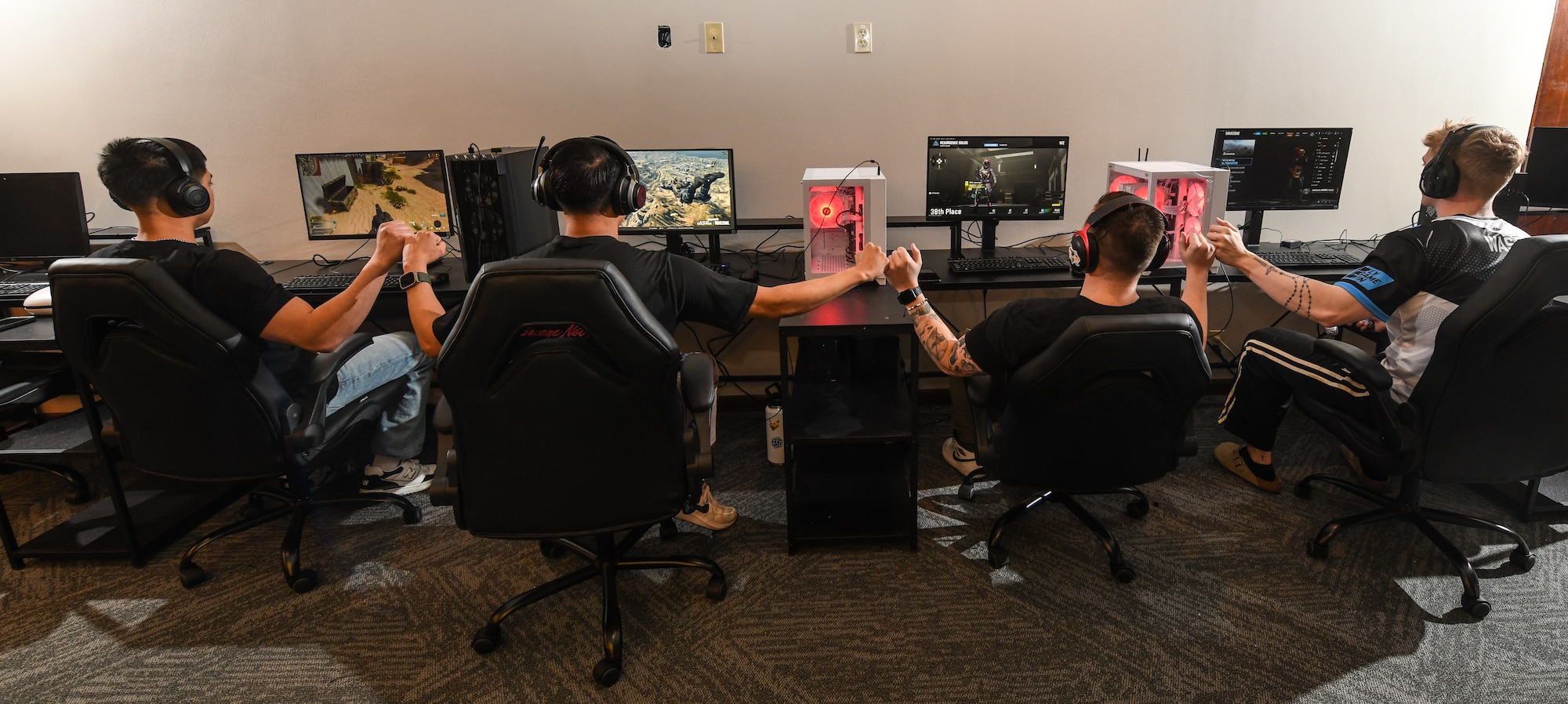 The Offutt Air Force Base esports team fist bump each other after completing a round of Call of Duty at the Offutt Event Center, March 7, 2025. The team is preparing to play in the Eastern Qualifier tournament at Patrick AFB on June 8-15. (U.S. Air Force photo by Chad Watkins)