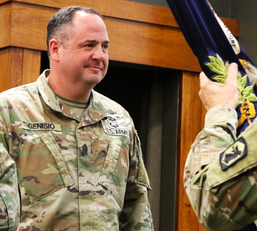 Command Sgt. Maj. Jonathan Genisio waits to receive the 129th Regiment (Regional Training Institute) guidon during the regiment's Change of Responsibility Ceremony.