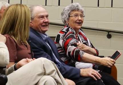 Illinois Army National Guard Command Sgt. Jonathan Genisio's parents, Barbara and Bob Genisio, laugh during their son's retirement ceremony.