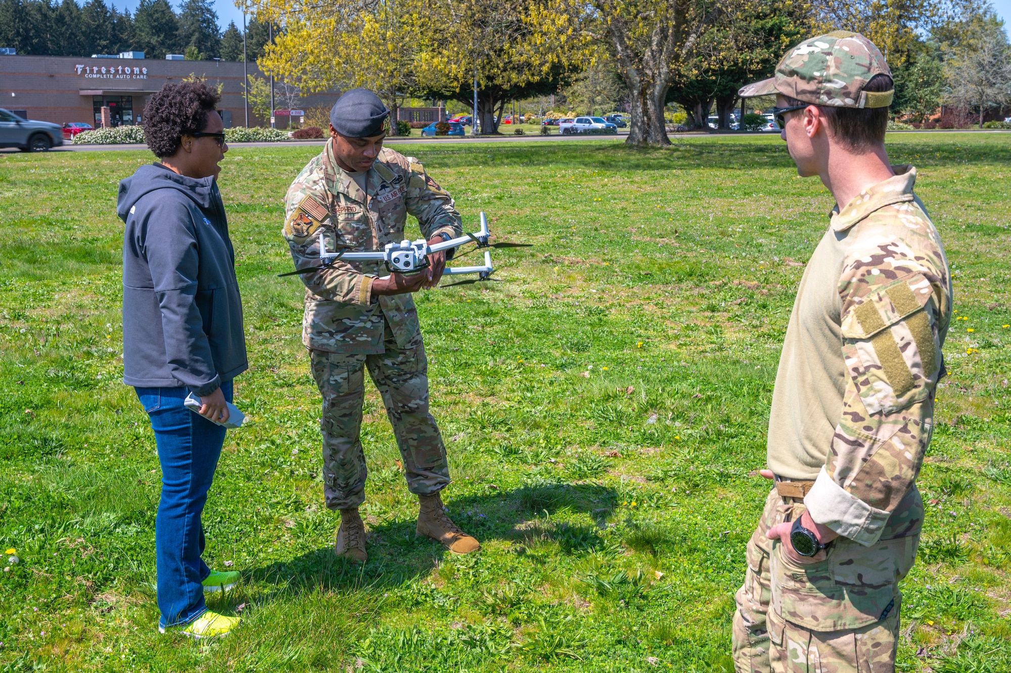 A Skydio employee and two U.S. Air Force Airmen examine Skydio’s X10D drone at Joint Base Lewis-McChord, Washington, April 23, 2025.