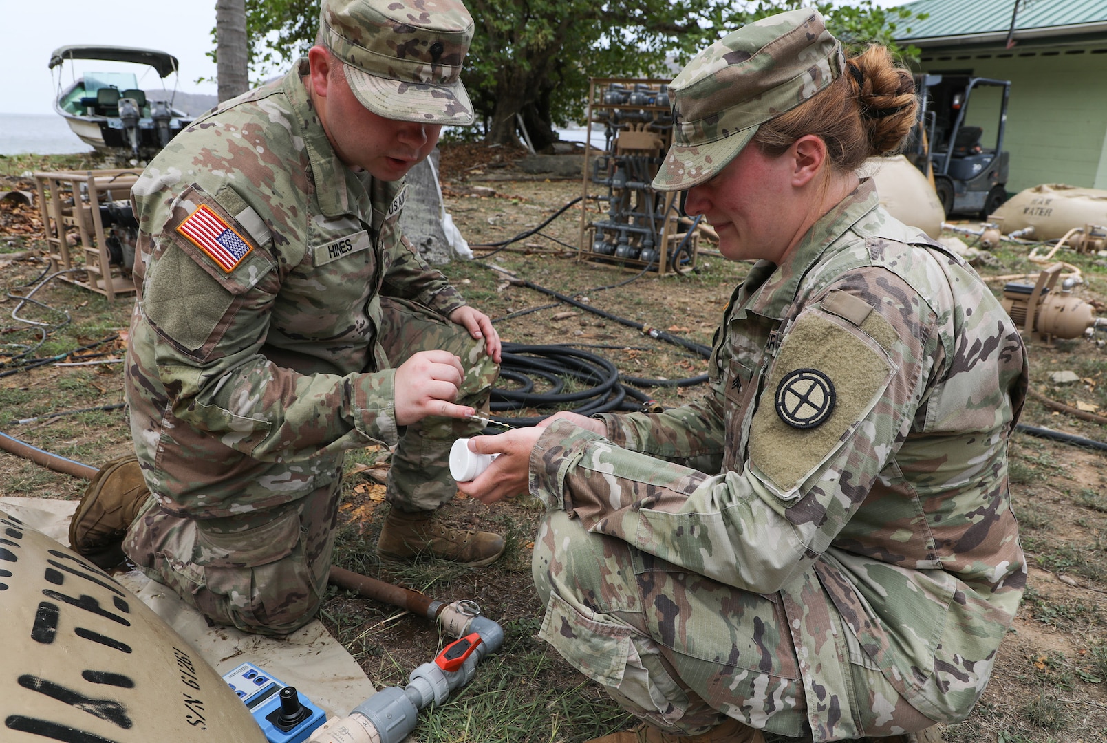 Spc. Colton Hines, left, and Sgt. Jessica Shields, water purifications specialists with the 935th Aviation Support Battalion, Missouri Army National Guard, check the chlorine levels of the water meant for cooking and cleaning laundry during TRADEWINDS 25 (TW25) exercise at Teteron Bay, Trinidad and Tobago, April 27, 2025.