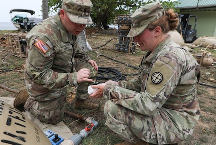 Spc. Colton Hines, left, and Sgt. Jessica Shields, water purifications specialists with the 935th Aviation Support Battalion, Missouri Army National Guard, check the chlorine levels of the water meant for cooking and cleaning laundry during TRADEWINDS 25 (TW25) exercise at Teteron Bay, Trinidad and Tobago, April 27, 2025.