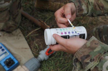 Sgt. Jessica Shields, a water purification specialist with the 935th Aviation Support Battalion, Missouri Army National Guard, checks the chlorine levels of the water meant for cooking and cleaning laundry during TRADEWINDS 25 exercise at Teteron Bay, Trinidad and Tobago, April 27, 2025.