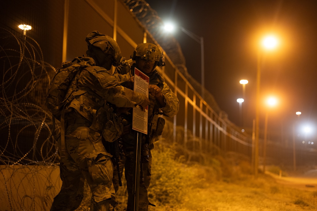 U.S. Soldiers, assigned to Alpha Company, 1st Battalion, 12 Infantry Regiment, enplace signs in order to establish the El Paso National Defense Area at El Paso, Texas, (TXNDA) April 30, 2025