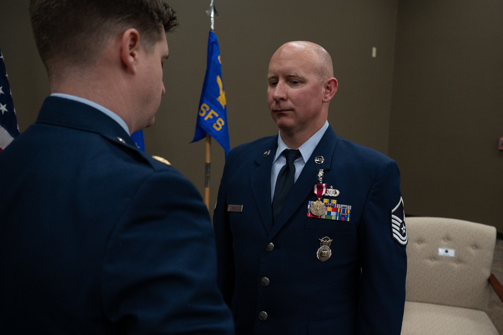 Maj. Tyler Freeman, 932nd SFS commander awards Master Sgt. Donald Miller, 932nd Security Forces Squadron, the Meritorious Service Medal during his retirement ceremony on April 5, 2025, Scott Air Force Base, Illinois. Miller received the Meritorious Service Medal for his constant innovation and devotion to the SFS. (U.S. Air Force photo by Senior Airman Benjamin Cowles)