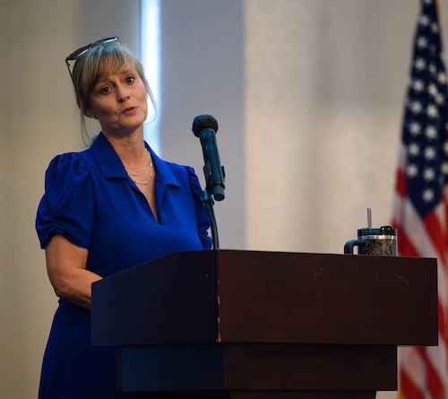 Woman speaks at podium.
