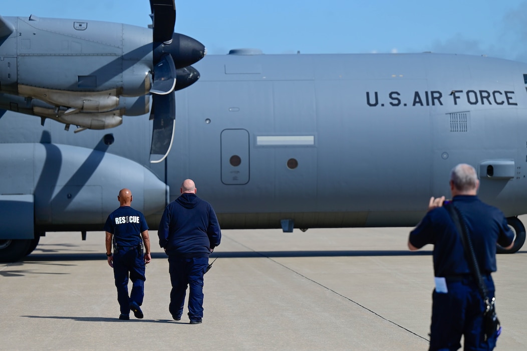 A group of men walking to a plane