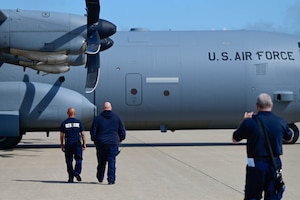 A group of men walking to a plane
